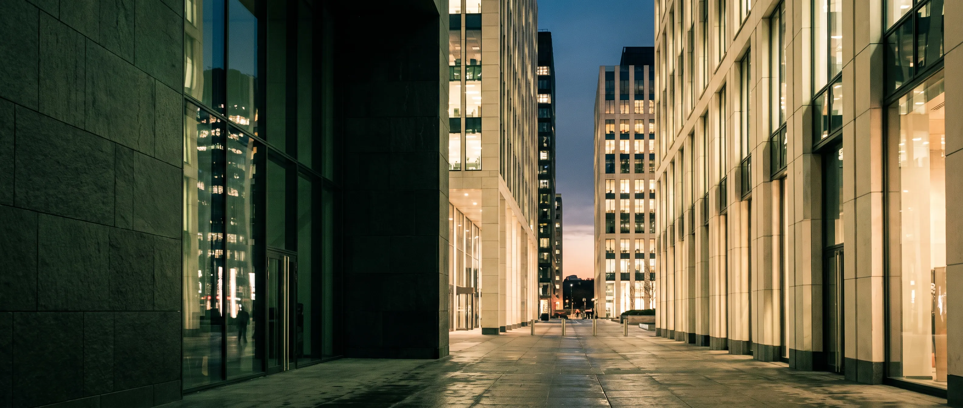 Modern stone and glass office buildings in warm evening light